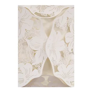 Close-up detail of white pearlescent laser-cut floral wedding invitation card