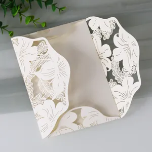 Elegant laser cut cream wedding invitation card with intricate floral lace detail