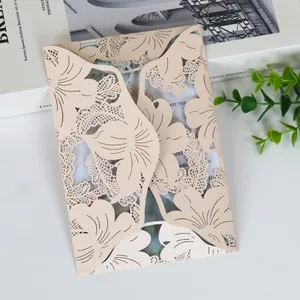 Detailed view of champagne laser-cut hollow leaf pattern wedding invitation card