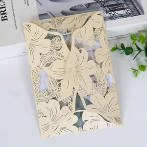 Detailed close-up of cream laser-cut hollowed-out invitation card with floral patterns