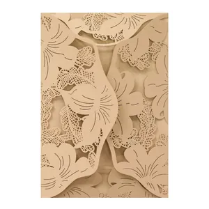 Intricate macro view of champagne gold laser-cut floral pattern wedding invitation card