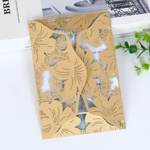 Elegant gold laser-cut wedding invitation card featuring intricate floral and leaf pattern details