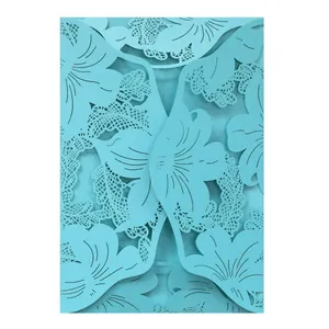Intricate macro view of a light blue laser cut floral pattern on a wedding invitation