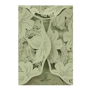 Detail view of the intricate laser-cut floral pattern on olive green invitation card