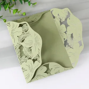 Detail view of a sage green laser-cut floral leaf pattern for wedding invitation cover