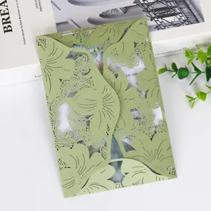 Close-up of green laser-cut hollow leaf pattern on European wedding invitation card