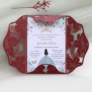 Close-up of burgundy laser-cut floral invitation with elegant printed inner card