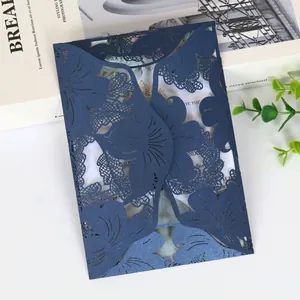 Detail shot of navy blue laser-cut wedding invitation with leaf patterns
