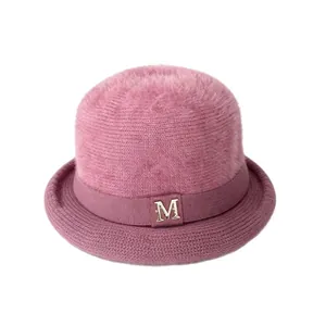 Elegant pink fuzzy rabbit fur knit bowler hat with decorative metallic M logo detail