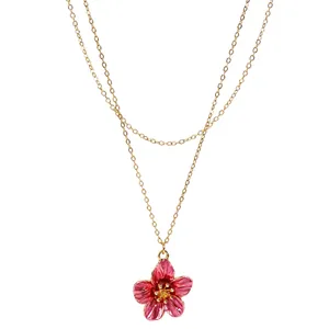 Elegant gold chain necklace featuring a vibrant pink drip oil flower pendant detail