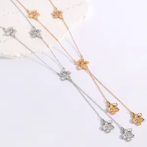 Detailed view of gold and silver flower motif necklaces with textured petal patterns