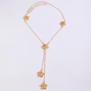 Detail shot of a golden flower pendant necklace with elegant Y-shaped drop design