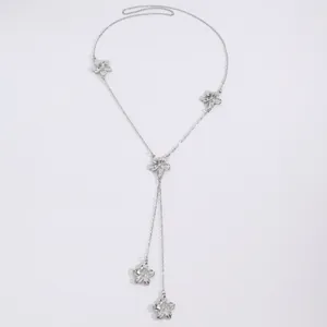 Detailed close-up of elegant silver Y-shaped flower necklace with textured shell-like petals