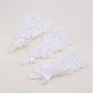 Detail of three different white lace headband patterns with delicate satin bows.