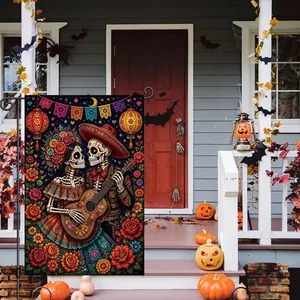 Detailed view of a Day of the Dead garden flag with skeleton design on a porch.