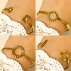 Detailed view of four vintage gold alloy bangles featuring heart and sun pattern designs.