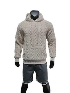 Detailed view of men's beige teddy fleece hoodie featuring an embossed jacquard texture