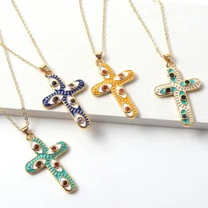Cross necklaces with colorful enamel evil eye pendants on fine gold chains.