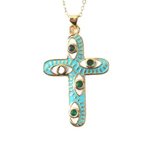 Gold-plated cross pendant necklace with blue enamel and evil eye eye patterns.