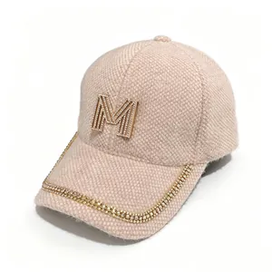 Side view of mink velvet baseball cap with rhinestone M logo and brim chain decoration