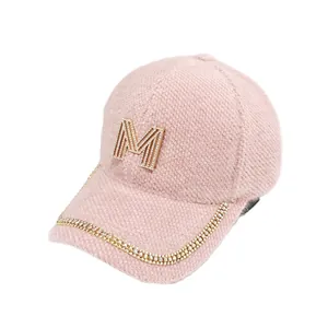 Stylish pink fleece baseball cap for women featuring rhinestone M logo and chain decoration
