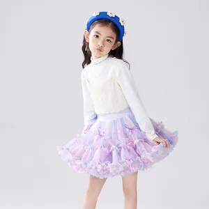 Full shot of girl wearing a colorful layered bow tutu skirt in a clean studio setting