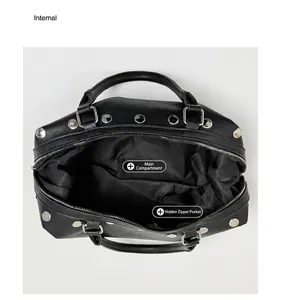 Internal view of the black rivet tote bag showing main compartment and zipper pocket detail