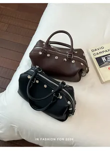 Close-up of black and brown retro studded handbags with metallic hardware