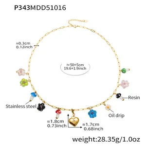 Detailed view of colorful resin mushroom and heart charms on a gold stainless steel chain.