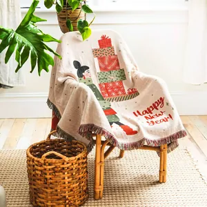 Cozy bohemian woven throw blanket with festive Happy New Year design and tassels.