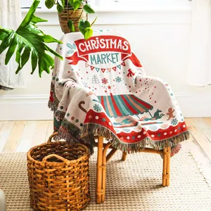 Cozy woven Christmas throw blanket with festive tassels draped over a chair for home decor
