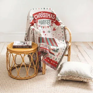 Cozy woven Christmas market throw blanket with tassel fringe draped gracefully on a chair