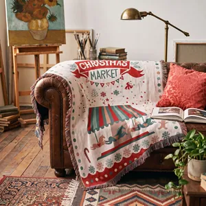 Detailed woven Christmas Market throw blanket with festive carousel design on a sofa.