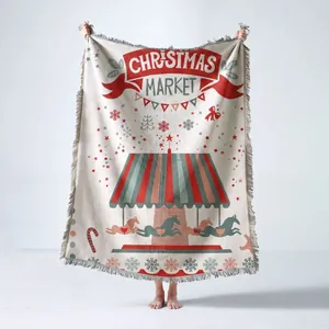 Detailed view of woven Christmas throw blanket featuring carousel design and soft fringes