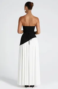 Detailed back view of an elegant strapless black corset top with white pleated maxi skirt
