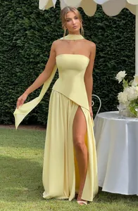 Elegant yellow strapless maxi dress with high slit and matching neck scarf