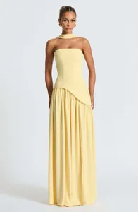 Elegant pale yellow strapless maxi dress with asymmetrical waist and neck scarf