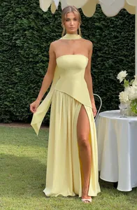 Elegant pale yellow strapless maxi dress with high slit and asymmetric waist design