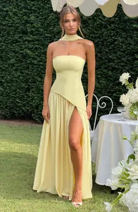 Elegant pale yellow strapless maxi dress with high leg slit and matching neck sash