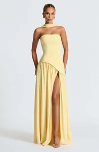Detail shot of elegant strapless yellow maxi dress with high side slit on model.