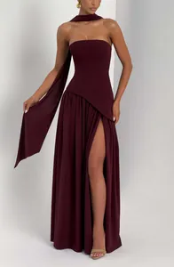 Visual detail of a dark burgundy strapless maxi dress with a high slit and neck scarf