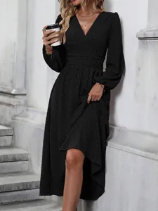 Detailed view of black Swiss dot maxi dress featuring a ruched waist and lantern sleeves