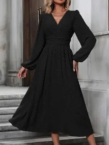 Detail of black V-neck puff sleeve dress with pleated waist and Swiss dot texture.