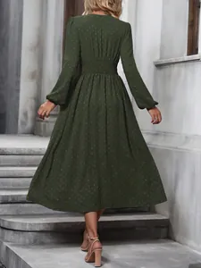 Back view of army green lantern sleeve midi dress with smocked waist and Swiss dots