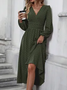 Detailed macro view of army green lantern sleeve dress featuring pleated waist and dots.