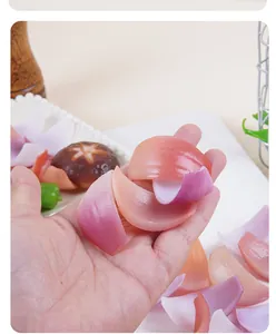 Macro detail of realistic faux onion slices being held to show texture and scale.