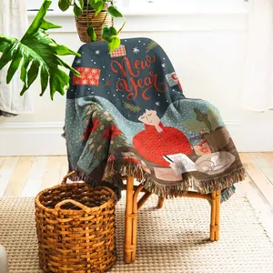 Close-up of woven throw blanket with festive New Year illustration and fringe edges.