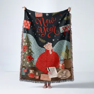 Detailed view of festive woven throw blanket with New Year illustration and fringe