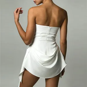 Back view of a chic white strapless mini dress with an asymmetric draped hem