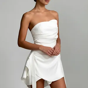 Detail of elegant white strapless French dress with irregular hem and pleated bodice.